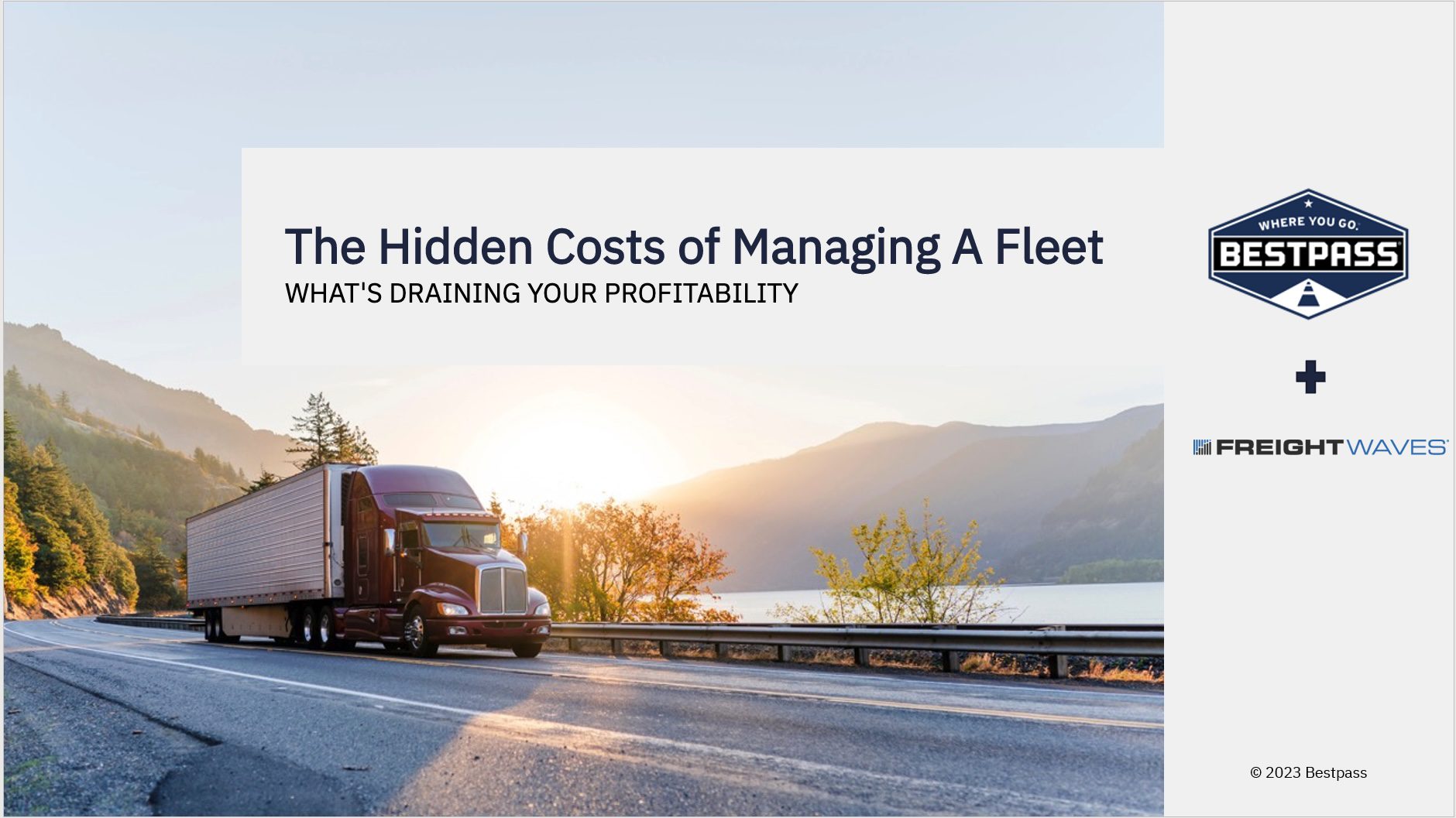 A truck driving along a scenic highway, representing the hidden costs of managing a fleet.