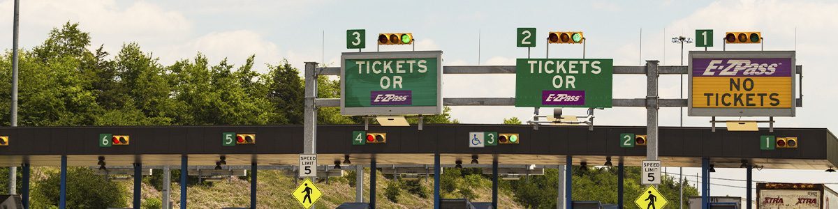 E-ZPass toll plaza showing electronic toll collection lanes and ticketed lanes for vehicles on a U.S. toll road.