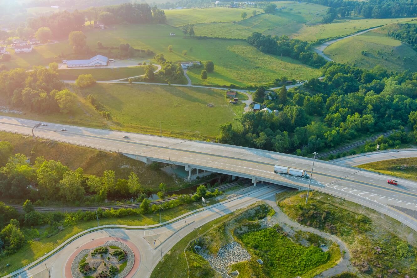 Aerial view of a commercial truck traveling on a highway near inspection routes, representing ISS score and safety compliance.