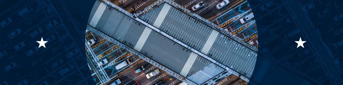 Overhead view of vehicles crossing a toll bridge, representing electronic tolling systems and toll violation enforcement.