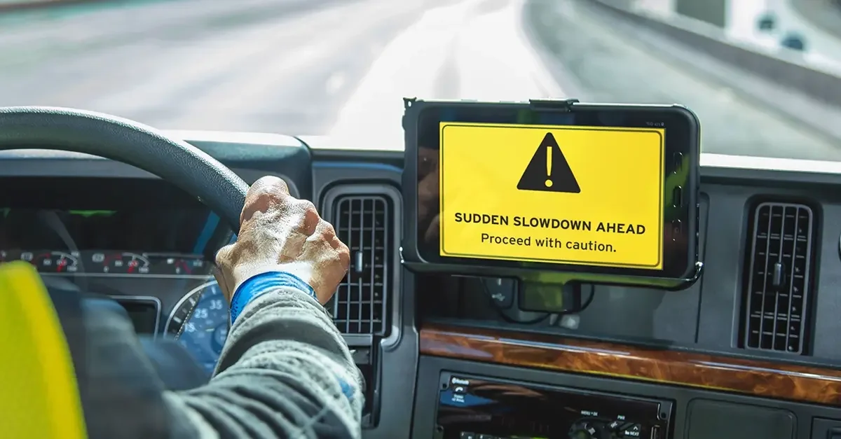 In-cab alert showing a sudden slowdown warning on a truck dashboard
